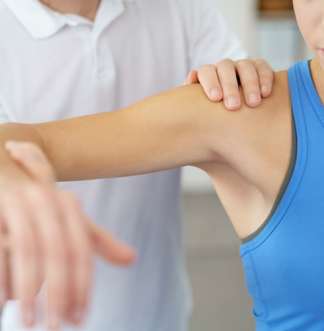 Close,Up,Professional,Physical,Therapist,Lifting,The,Arm,His,Female